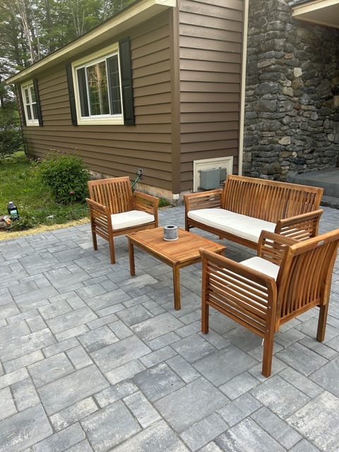 Patio off the kitchen with grill and fire pit.  Faces east