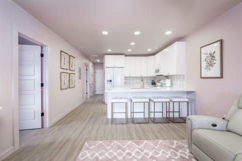 View from the living room into the kitchen and bar seating