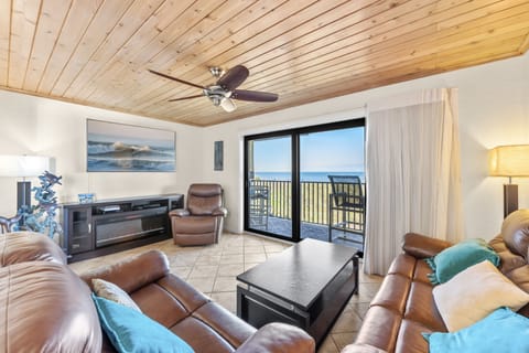 Cozy living space with warm wood accents and breathtaking oceanfront views.