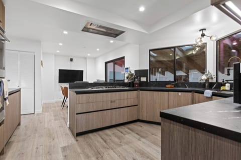 Gourmet kitchen with stainless steel appliances and breakfast nook.