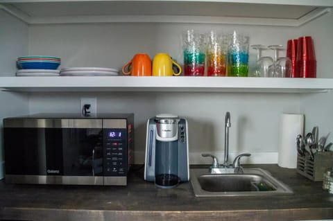 Kitchenette also includes a coffee maker, dishes, silverware, and a mini-sink.