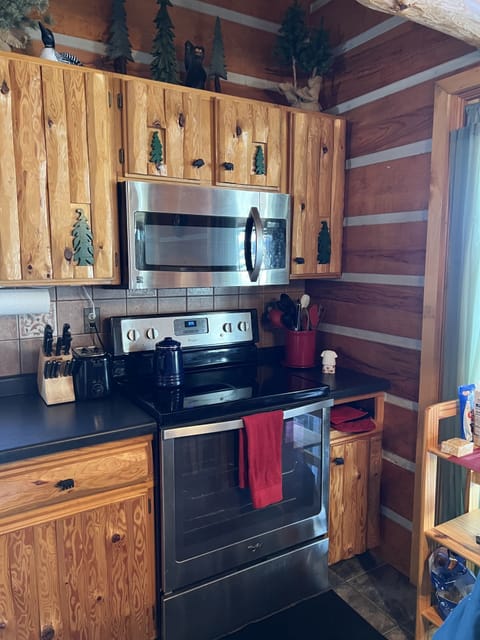 Kitchen with new gas convection range, microwave, dishwasher, coffee maker.
  