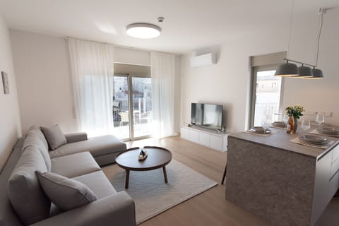 Bright living room with a comfortable sofa and TV with Netflix 