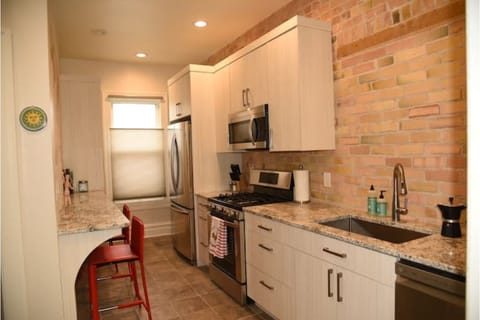 Modern dream kitchen against a backdrop of exposed 100 + year old brick.  