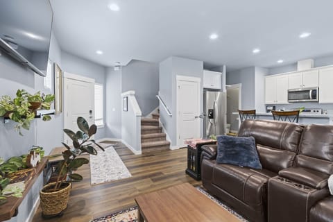 Well appointed living room area with plush sofa with THREE RECLINERS!