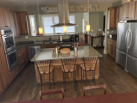 Kitchen island w/ 6 gas burners. 2 refrigerators, double oven, 2 d/w, microwave