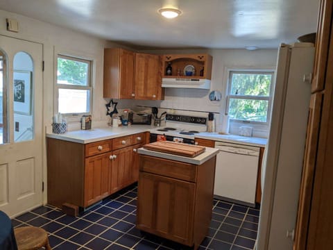 The kitchen is off the porch entrance and has a small eating area.