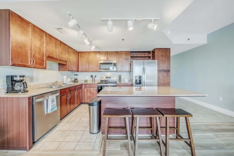 Fully equipped kitchen features granite countertops and stainless-steel appliances.