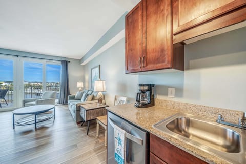 Fully equipped kitchen features granite countertops and stainless-steel appliances.