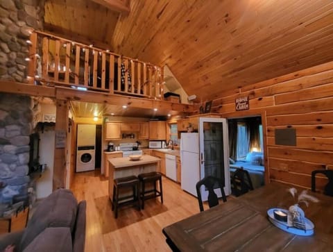 A look at the dining area and kitchen in the cabin with the loft above.