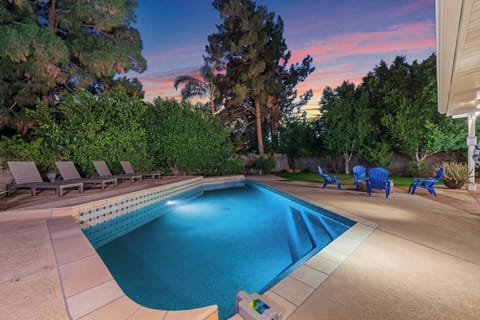 Large private backyard with heated swimming pool