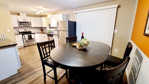 Dining table has 4 chairs.  2 stools next to counter to seat 6. 