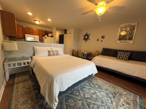 Studio sleeping area with a queen bed and twin bed