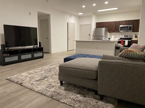 Comfy spacious living room with 65 inch smart TV 