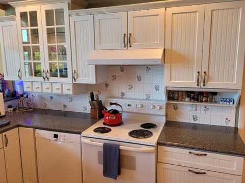 KITCHEN (SECOND FLOOR):  The home has a large kitchen with all appliances including a dishwasher.  Also includes a good supply of cooking and dining utensils.