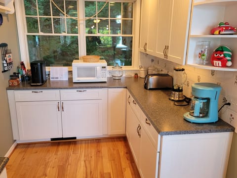 KITCHEN (SECOND FLOOR):  The home has a large kitchen with all appliances including a dishwasher.  Also includes a good supply of cooking and dining utensils.