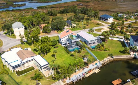 Waterfront canal property with private dock, heated saltwater pool, fire pit area, and spacious yard. 