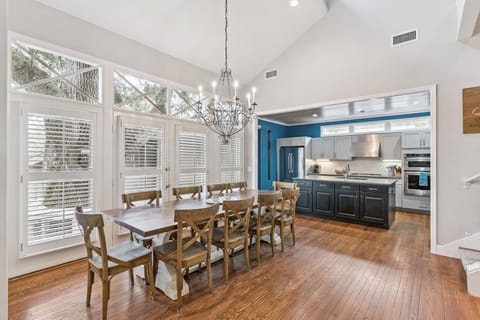 Gather around your elegant dining table under vaulted ceilings, with a modern kitchen steps away for easy meal prep.