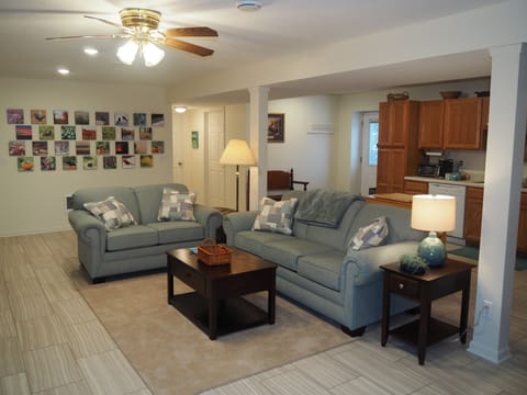LIVING ROOM:  The apartment has a very comfortable living room with a sleeper sofa, comfy chair, ceiling fan, table, and television.
