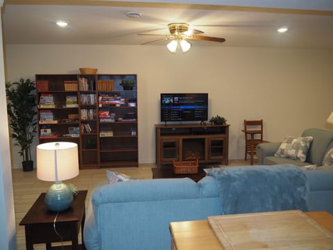 LIVING ROOM:  The apartment has a very comfortable living room with a sleeper sofa, comfy chair, ceiling fan, table, and television.