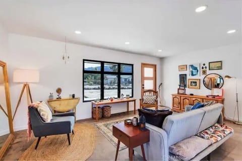Livingroom with view of front door and wide window with view of mountains