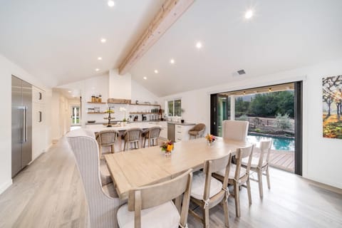 Bright open dining and kitchen area with pool access