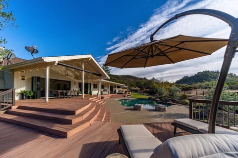 Spacious outdoor patio with panoramic mountain views and lounge seating