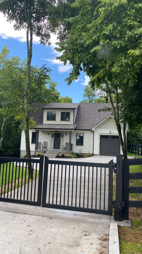 Fenced and gated entry for this private home on a wooded lot