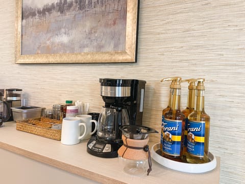 Coffee bar w/ a variety of coffees, teas, creamers, sweeteners, Torani syrups