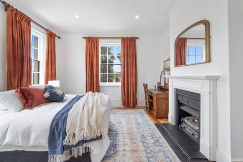 The generous primary bedroom comes with a plush king-sized bed, a decorative fireplace and a dedicated workspace.