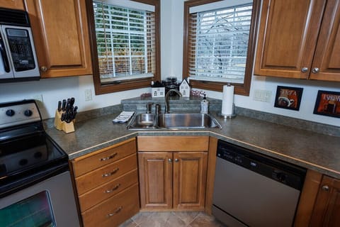 Fully stocked kitchen offers cookware, dishes, and utensils