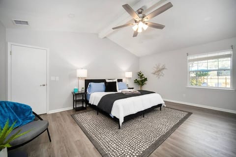 Unwind in this serene and airy bedroom, complete with vaulted ceilings and a touch of modern comfort.
