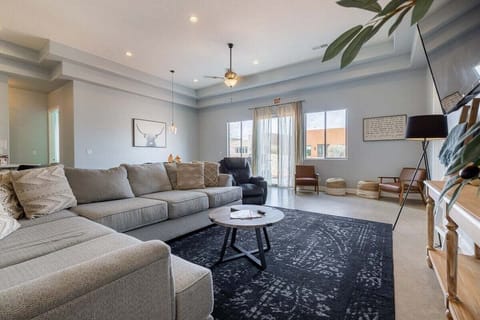 The living room is spacious and hosts a multitude of seating for everyone to congregate comfortably.