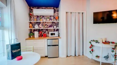 Coffee bar which has a microwave, toaster, coffee maker and a mini-fridge.