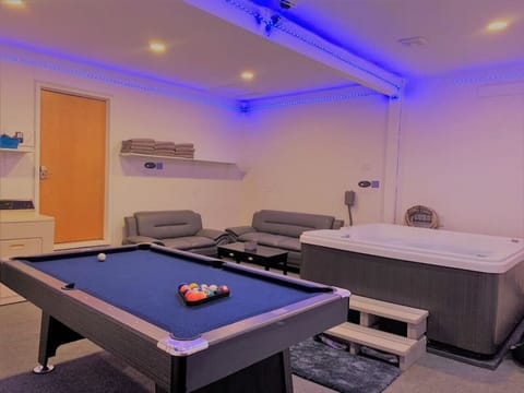 Relax and play: hot tub and pool table all in one room