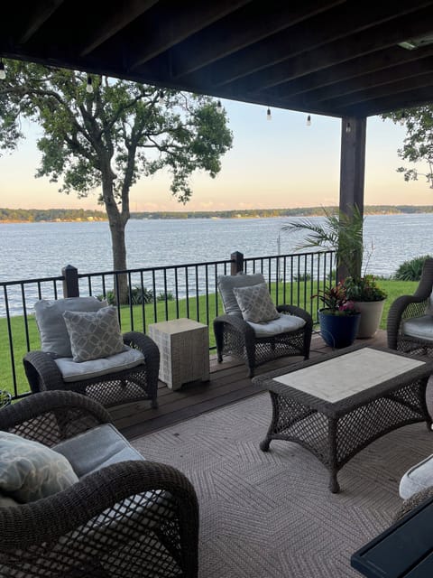 Main level deck with covered patio living room, dining, and hot tub
