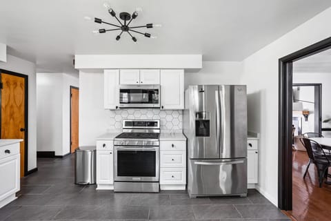 Kitchen w/ gas stove , gas oven, microwave, dishwasher, 3 door fridge