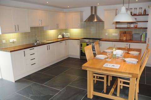 The large, well-equipped kitchen seats 6 for dining on home cuisine.