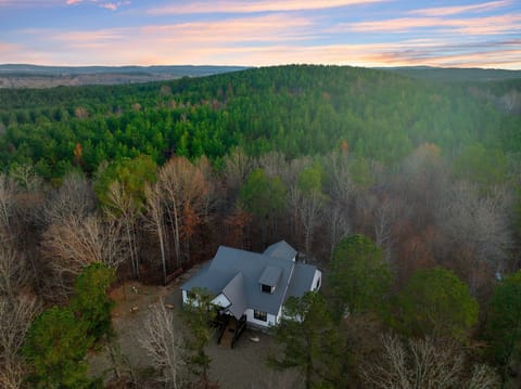 Exterior Oasis: Nestled among towering pines, enjoy breathtaking sunsets from your private retreat!