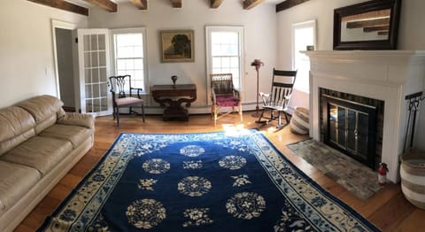 Second living room, with wood fireplace, record player, and chess table