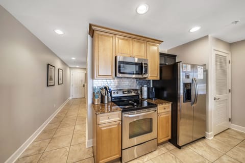The fully equipped kitchen features granite countertops, stainless-steel appliances, and has everything you need to prepare meals for family and friends.
