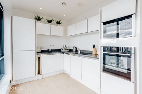 The kitchen is fully equipped with integrated appliances