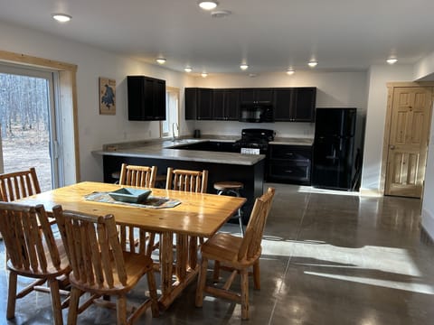 Dining room to kitchen with sliding door to the patio.