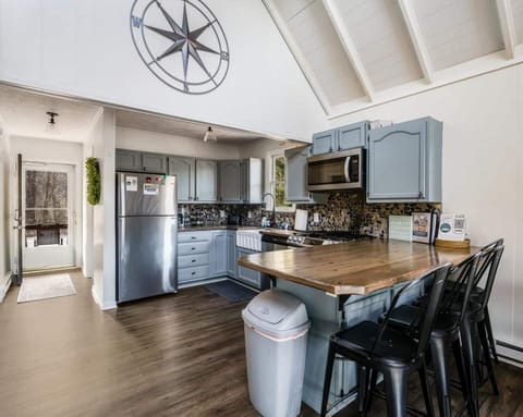 The kitchen is a true standout, featuring beautiful wood countertops, sleek stainless-steel appliances, and a unique river rock backsplash. It’s the perfect space to cook, entertain, or simply enjoy the stunning details.