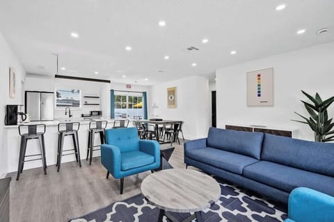 Gather in this spacious living-dining-kitchen combo with modern decor and natural light — perfect for group stays.