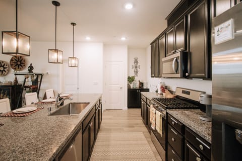 Fully stocked galley kitchen, granite countertops & stainless steel appliances