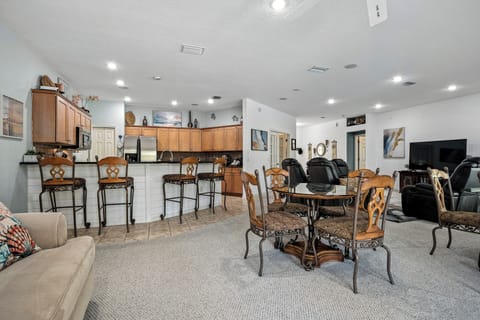 Sofa/Queen pull out couch with view into dining area and kitchen.