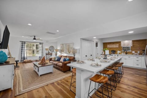 Spacious open-concept layout with large kitchen island, living room seating, and room for everyone to gather.