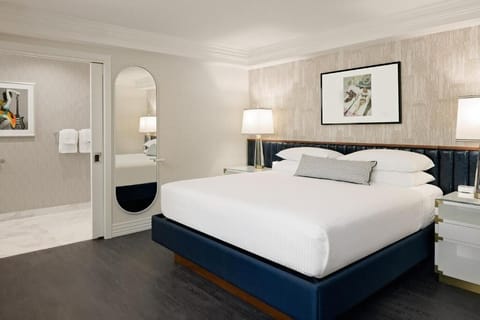 Recharge in a serene bedroom with soft lighting and luxe headboard.