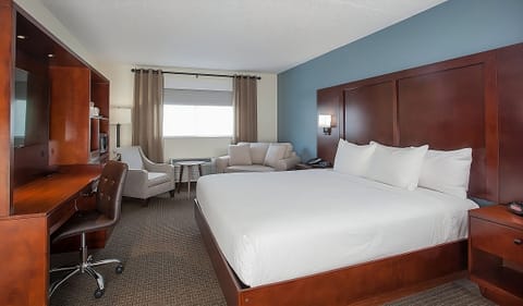 Settle into crisp linens beside a convenient work desk.